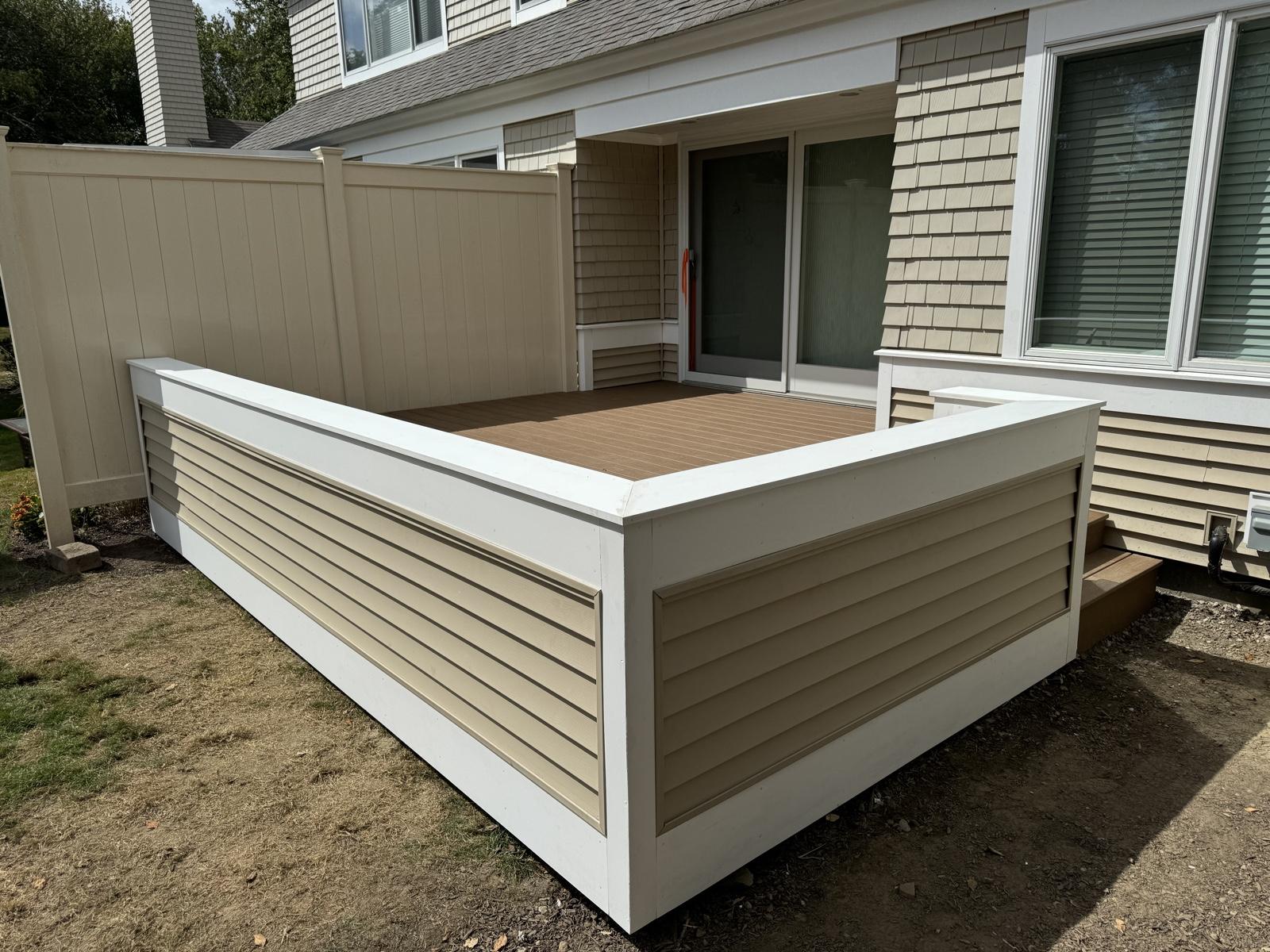 After: Deck replacement — dated composite deck replaced with a custom-built deck with privacy walls