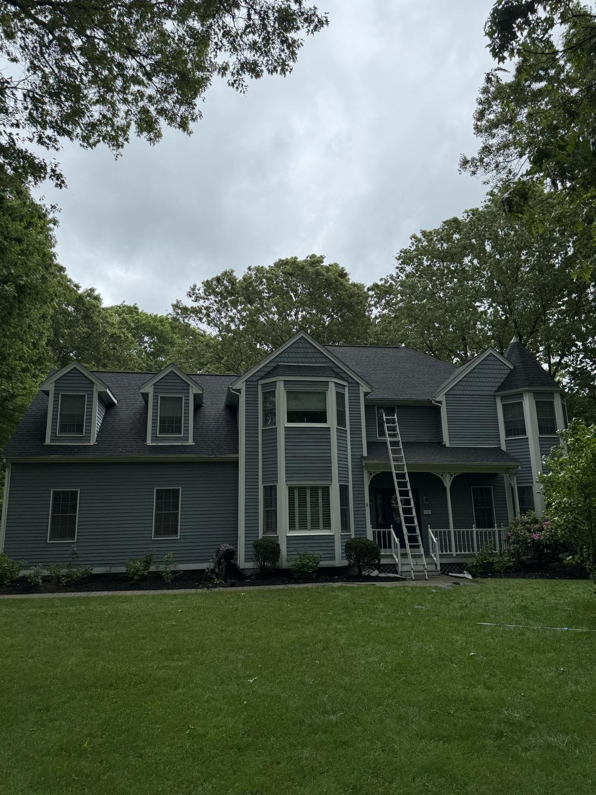 After: Full roof replacement — tear-off with underlayment exposed replaced with a finished architectural shingle roof